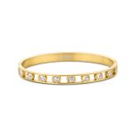 Gold plated stainless steel bangle with white round zirconia stones on a white background