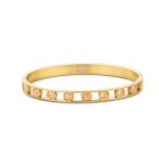 Gold plated stainless steel bangle with orange round zirconia stones on a white background